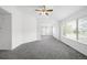 Open living space with neutral carpet and large windows for natural light at 6193 Terry Ct, Arvada, CO 80403