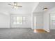 Bright living room with vaulted ceilings, neutral paint, and large windows at 6193 Terry Ct, Arvada, CO 80403