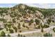Aerial view showing a mountain home with a long winding driveway at 6640 Kilimanjaro Dr, Evergreen, CO 80439
