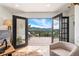Balcony features stunning mountain views accessible from the light-filled living area at 6640 Kilimanjaro Dr, Evergreen, CO 80439