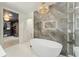 Elegant bathroom with a freestanding tub, marble accents, and contemporary fixtures at 6640 Kilimanjaro Dr, Evergreen, CO 80439