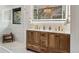 A beautifully designed bathroom with a double vanity, gold fixtures, and stylish lighting at 6640 Kilimanjaro Dr, Evergreen, CO 80439