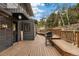 Outdoor deck with grill and exterior entry to house at 6640 Kilimanjaro Dr, Evergreen, CO 80439
