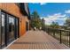 Exterior deck with chairs and entry to house at 6640 Kilimanjaro Dr, Evergreen, CO 80439