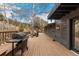 Exterior wooden deck featuring grill and outdoor seating at 6640 Kilimanjaro Dr, Evergreen, CO 80439