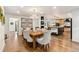 Bright dining area featuring a wooden table, upholstered chairs, and an eye-catching antler chandelier, open to the kitchen at 6640 Kilimanjaro Dr, Evergreen, CO 80439