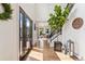 Bright entryway features hardwood floors, a modern staircase, and stylish decor accents with natural light at 6640 Kilimanjaro Dr, Evergreen, CO 80439
