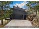 Spacious garage and driveway, adjacent to rear patio and home entrance at 6640 Kilimanjaro Dr, Evergreen, CO 80439