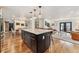 Open concept kitchen and dining area showcasing a large kitchen island with seating at 6640 Kilimanjaro Dr, Evergreen, CO 80439