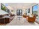 Open-concept living room with a stylish seating arrangement and walkout to the deck with scenic views at 6640 Kilimanjaro Dr, Evergreen, CO 80439