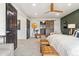 Spacious main bedroom with a barn door, stylish decor, and a cozy seating area at 6640 Kilimanjaro Dr, Evergreen, CO 80439