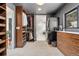 A walk-in closet with custom shelving, laundry area and access to the main bathroom at 6640 Kilimanjaro Dr, Evergreen, CO 80439