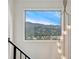 Staircase window view of picturesque mountain scenery at 6640 Kilimanjaro Dr, Evergreen, CO 80439