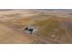 Aerial view of the property, including the house, outbuildings, and surrounding land at 6 Timberlake Ct, Byers, CO 80103