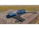 Beautiful aerial view of the single-story home with a long driveway, and a detached garage, surrounded by farmland at 6 Timberlake Ct, Byers, CO 80103