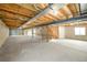 Unfinished basement featuring concrete walls, exposed ductwork, and wooden support beams at 6 Timberlake Ct, Byers, CO 80103