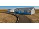 Charming single-story home with a well-manicured front yard and a detached garage, offering ample space at 6 Timberlake Ct, Byers, CO 80103