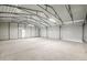 Spacious garage with three roll up doors and ample space for storage or vehicles at 6 Timberlake Ct, Byers, CO 80103
