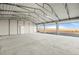 Open garage with roll up doors providing expansive views of the surrounding land at 6 Timberlake Ct, Byers, CO 80103