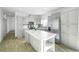 Modern kitchen with stainless steel appliances, marble countertops and gray cabinetry at 6 Timberlake Ct, Byers, CO 80103
