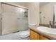 Bright bathroom with a glass enclosed shower and modern sink at 337 Ivory Cir, Aurora, CO 80011