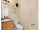 Well-lit half bathroom with a modern vanity and decorative shelves at 337 Ivory Cir, Aurora, CO 80011