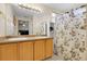 Bathroom featuring double sinks, ample counter space, and a floral shower curtain at 337 Ivory Cir, Aurora, CO 80011