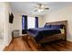 Bedroom with hardwood floors, ceiling fan, and large bed at 337 Ivory Cir, Aurora, CO 80011