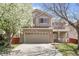 Charming two-story home with a two-car garage, blossoming tree, and a well-manicured lawn at 337 Ivory Cir, Aurora, CO 80011