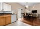 Open concept kitchen and dining area with granite counters, white appliances and a sliding glass door at 337 Ivory Cir, Aurora, CO 80011