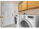 Well-equipped laundry room with a washer, dryer, and ample storage space at 337 Ivory Cir, Aurora, CO 80011