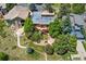 An aerial view of the house, showcasing its backyard, patio, and surrounding greenery at 6457 Willow Broom Trl, Littleton, CO 80125