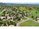 Scenic aerial view showcasing a home nestled in a picturesque community with lush landscape and a golf course at 6457 Willow Broom Trl, Littleton, CO 80125