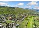 Breathtaking aerial view of a golf course community nestled within rolling hills and mature trees at 6457 Willow Broom Trl, Littleton, CO 80125