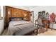 Bedroom featuring wood panel accent wall, desk, and a seating bench at 6457 Willow Broom Trl, Littleton, CO 80125