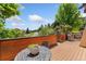 Inviting deck featuring a small table, chair, wood railing, and serene neighborhood views at 6457 Willow Broom Trl, Littleton, CO 80125