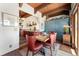 Charming dining area with wood table, red upholstered chairs, and stylish lighting at 6457 Willow Broom Trl, Littleton, CO 80125