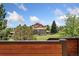 A scenic view of the home and the surrounding landscape with trees, blue sky, and mountains at 6457 Willow Broom Trl, Littleton, CO 80125