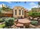 Inviting front entrance with a stone patio, bench, and charming Southwestern architectural details at 6457 Willow Broom Trl, Littleton, CO 80125