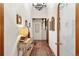 Hallway boasts Saltillo tile floors, soft lighting, neutral walls, and decorative artwork at 6457 Willow Broom Trl, Littleton, CO 80125