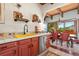 Bright kitchen area featuring colorful tile countertops, cabinets, and stainless steel appliances at 6457 Willow Broom Trl, Littleton, CO 80125