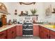 Quaint kitchen with unique colorful countertops, cabinets, and stainless steel appliances at 6457 Willow Broom Trl, Littleton, CO 80125