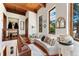 Bright landing area with terra cotta floors, a built-in bench, Southwestern accents, and multiple windows at 6457 Willow Broom Trl, Littleton, CO 80125