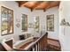 Landing area with tile floor, wooden ceiling, decorative pillows and multiple view-filled windows at 6457 Willow Broom Trl, Littleton, CO 80125