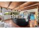 Inviting living room with wood floors, beamed ceilings, and a comfortable seating area at 6457 Willow Broom Trl, Littleton, CO 80125