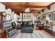 Cozy living room featuring wood beam ceilings, fireplace, and comfortable seating arrangement at 6457 Willow Broom Trl, Littleton, CO 80125