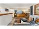 Cozy living room with eclectic furniture, wood accents, and a black shuttered window at 6457 Willow Broom Trl, Littleton, CO 80125