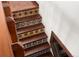 Stairway with wood treads and decorative tile risers at 6457 Willow Broom Trl, Littleton, CO 80125