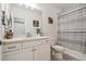 Bright bathroom featuring a white vanity with quartz countertops and a shower with a striped curtain at 171 S Waterloo St, Aurora, CO 80018