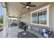 Relaxing covered patio with comfortable seating, ceiling fan and string lights perfect for outdoor entertaining at 171 S Waterloo St, Aurora, CO 80018